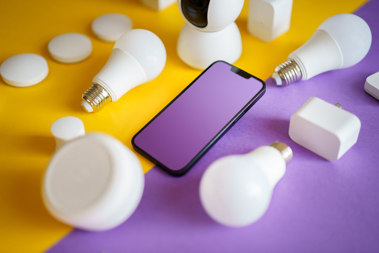 Services Colorful flat lay of smart home devices and smartphone on vibrant background, ideal for technology concepts.