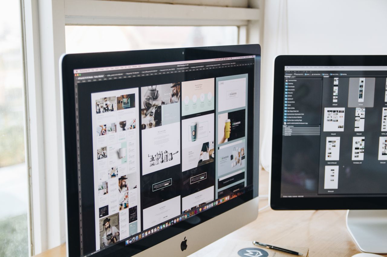 About Modern office desk setup with dual monitors displaying design software, ideal for tech and business themes.