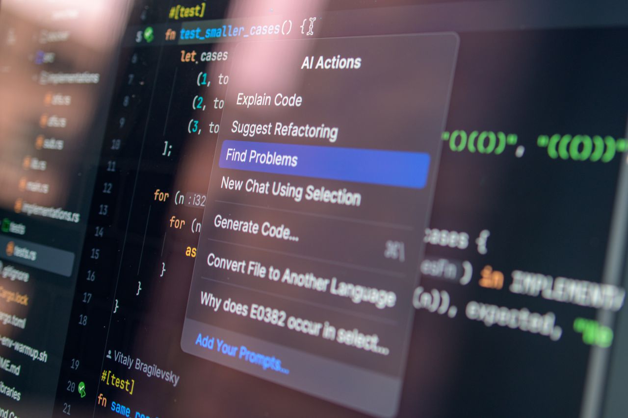 Services Close-up of AI-assisted coding with menu options for debugging and problem-solving.