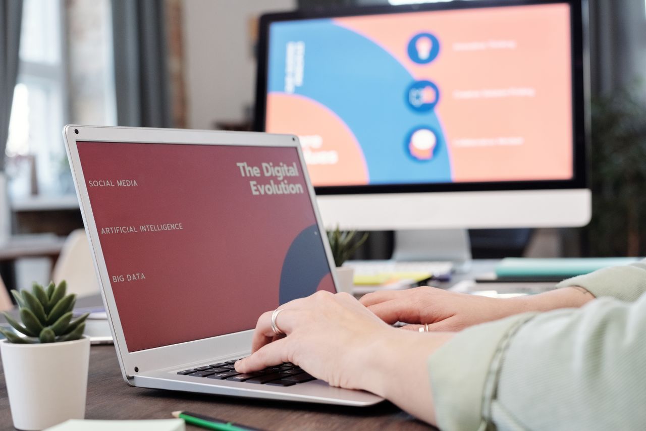 About Laptop user typing with digital evolution concept on screen in a modern office environment.